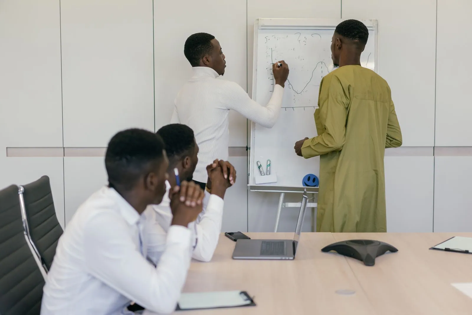 Colleagues planning together at a whiteboard